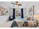 Comfortable bedroom featuring a ceiling fan, inviting natural light through a window, and stylish décor at 17960 Weymouth Ave, Parker, CO 80134