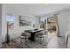 Bright dining area with modern table and chairs next to sliding glass door to fenced backyard at 17960 Weymouth Ave, Parker, CO 80134