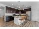 Modern kitchen with stainless steel appliances, granite countertops, and a center island with bar seating at 17960 Weymouth Ave, Parker, CO 80134