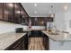 Modern kitchen featuring stainless steel appliances, granite countertops and stylish dark wood cabinetry at 17960 Weymouth Ave, Parker, CO 80134