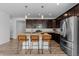 Modern kitchen featuring granite counters, stainless appliances, and breakfast bar seating, perfect for casual dining at 17960 Weymouth Ave, Parker, CO 80134