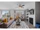 Bright living area featuring a cozy fireplace, comfortable sofas, and plenty of natural light at 17960 Weymouth Ave, Parker, CO 80134