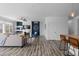 Bright and open living room featuring stylish decor, wood flooring, and seamless transition to kitchen area at 17960 Weymouth Ave, Parker, CO 80134