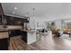 Open-concept living space seamlessly connects kitchen with island seating to the bright dining and living areas at 17960 Weymouth Ave, Parker, CO 80134