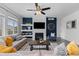 Inviting living room features a fireplace, ceiling fan, and stylish decor for a cozy and modern feel at 17960 Weymouth Ave, Parker, CO 80134