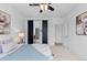 Bright main bedroom featuring a ceiling fan, sliding barn door and ensuite bathroom at 17960 Weymouth Ave, Parker, CO 80134