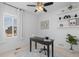 Bright office space features modern shelving and a ceiling fan at 17960 Weymouth Ave, Parker, CO 80134