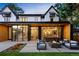 A modern patio includes a fire pit with seating, extending from an open home with glass doors at 346 Elm St, Denver, CO 80220