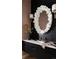 Modern bathroom with a stylish vanity, unique mirror, sconces, and a black accent wall at 346 Elm St, Denver, CO 80220