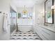 Bright bathroom featuring a modern tub, a glass enclosed shower, double vanity, and stylish fixtures at 346 Elm St, Denver, CO 80220