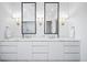 Modern bathroom featuring a double vanity, marble countertops, and sconces at 346 Elm St, Denver, CO 80220