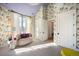 Airy bedroom showcasing decorative wallpaper, a sunny window, and stylish decor elements at 346 Elm St, Denver, CO 80220