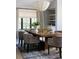 Bright dining room featuring a dark wood table, decorative lighting fixture, and a large window bringing in natural light at 346 Elm St, Denver, CO 80220