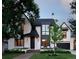 Striking two-story home featuring a modern design with a manicured lawn and beautiful landscaping at 346 Elm St, Denver, CO 80220