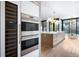 Modern kitchen with stainless steel appliances, a wine fridge, and a center island for gourmet cooking at 346 Elm St, Denver, CO 80220