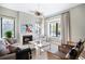 Cozy living room with a fireplace, modern decor, a decorative lighting fixture, and large windows at 346 Elm St, Denver, CO 80220