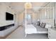 Bright main bedroom featuring a fireplace, canopy bed, decorative lighting fixture, and neutral decor at 346 Elm St, Denver, CO 80220