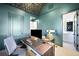 Inviting office space featuring a geometric patterned ceiling, custom built-ins, and an adjacent powder room at 346 Elm St, Denver, CO 80220
