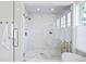 Luxurious shower showcasing marble tile, a glass door, and gold fixtures at 346 Elm St, Denver, CO 80220