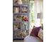 A close up on a stylish shelf, a purple couch pillow, and a white side table at 346 Elm St, Denver, CO 80220