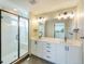 Modern bathroom featuring double sink vanity, large mirror, and glass-enclosed shower at 8500 W 62Nd Ave # D, Arvada, CO 80004