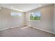 Light-filled bedroom with neutral walls, carpet, and bright windows at 8500 W 62Nd Ave # D, Arvada, CO 80004
