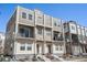 Contemporary townhome with stone accents, private balconies, and a well-maintained front entrance at 8500 W 62Nd Ave # D, Arvada, CO 80004