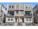 Modern townhome with stone accents, individual entrances, and small balconies at 8500 W 62Nd Ave # D, Arvada, CO 80004
