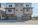 Modern townhome with two-car garage, neutral siding, and dark trim at 8500 W 62Nd Ave # D, Arvada, CO 80004