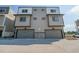 Modern townhome with two-car garage, neutral siding, and dark trim at 8500 W 62Nd Ave # D, Arvada, CO 80004