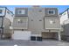 Rear exterior view of the townhome with a two-car garage and ample parking space at 8500 W 62Nd Ave # D, Arvada, CO 80004
