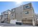 Modern townhome with garage, neutral siding, and well-lit exterior at 8500 W 62Nd Ave # D, Arvada, CO 80004