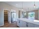 Open concept kitchen with stainless steel appliances, white cabinets, pantry and hardwood floors at 8500 W 62Nd Ave # D, Arvada, CO 80004