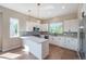 Modern kitchen with quartz counters, stainless steel appliances, and views from large window at 8500 W 62Nd Ave # D, Arvada, CO 80004