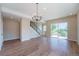 Spacious living room featuring hardwood floors, modern staircase and sliding glass door to balcony at 8500 W 62Nd Ave # D, Arvada, CO 80004