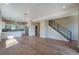 Open-concept living space featuring hardwood floors and modern staircase at 8500 W 62Nd Ave # D, Arvada, CO 80004