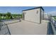 Spacious roof deck with modern railings, door to upper level, and city views at 8500 W 62Nd Ave # D, Arvada, CO 80004