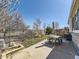 This backyard features a concrete patio, seating area, and a fire pit, ideal for outdoor living at 24704 E Chenango Dr, Aurora, CO 80016