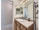 The bathroom boasts a vanity with modern lighting, a cream countertop, and a stylish faucet at 24704 E Chenango Dr, Aurora, CO 80016