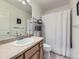 This bathroom features a vanity with cream countertop and a shower/tub combination with a white shower curtain at 24704 E Chenango Dr, Aurora, CO 80016