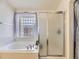 Relaxing bathroom area featuring a glass block window, soaking tub and shower at 24704 E Chenango Dr, Aurora, CO 80016