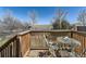A charming deck is set with a metal table and chairs, creating an inviting outdoor space at 24704 E Chenango Dr, Aurora, CO 80016