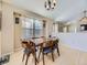 Charming dining area features a traditional chandelier and views of the living space at 24704 E Chenango Dr, Aurora, CO 80016