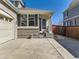 Inviting entrance with a covered porch, brick accents, and a well-manicured front yard at 24704 E Chenango Dr, Aurora, CO 80016