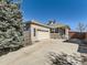 Charming exterior view of a brick home with a well-maintained front yard and large shade tree at 24704 E Chenango Dr, Aurora, CO 80016