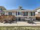 The rear of the home showcases a concrete patio, wooden deck and an inviting outdoor space at 24704 E Chenango Dr, Aurora, CO 80016