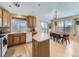 Bright kitchen with wooden cabinets, stainless steel appliances, and center island with seating at 24704 E Chenango Dr, Aurora, CO 80016