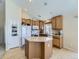 Functional kitchen with an island, light wood cabinets, and plenty of storage space at 24704 E Chenango Dr, Aurora, CO 80016