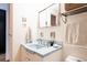 Bathroom vanity featuring tile floors, white cabinets and a blue sink at 1050 N Corona St # 312, Denver, CO 80218