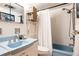 Bathroom with blue fixtures, a shower-tub combination, and vintage decor at 1050 N Corona St # 312, Denver, CO 80218